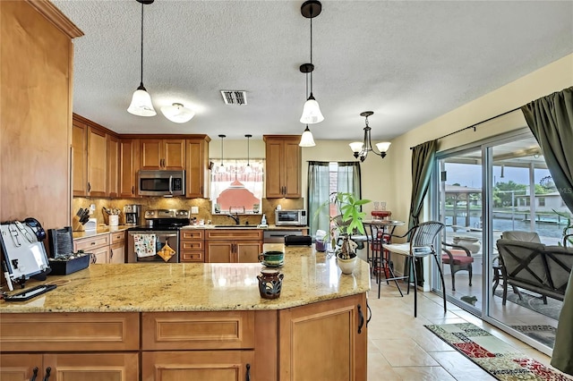 13814 Lavender Ave, Hudson, FL 34667 - kitchen featuring stainless steel appliances, a peninsula, tasteful backsplash, light stone countertops, and a textured ceiling