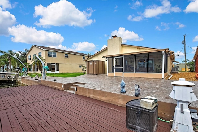13814 Lavender Ave, Hudson, FL 34667 - wooden deck with a sunroom