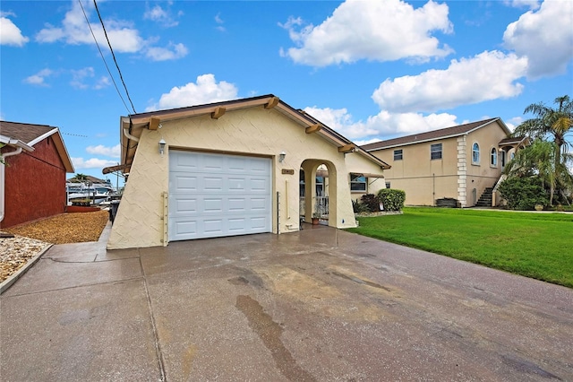 13814 Lavender Ave, Hudson, FL 34667 - view of front of property with a front yard, concrete driveway, stucco siding, and a garage