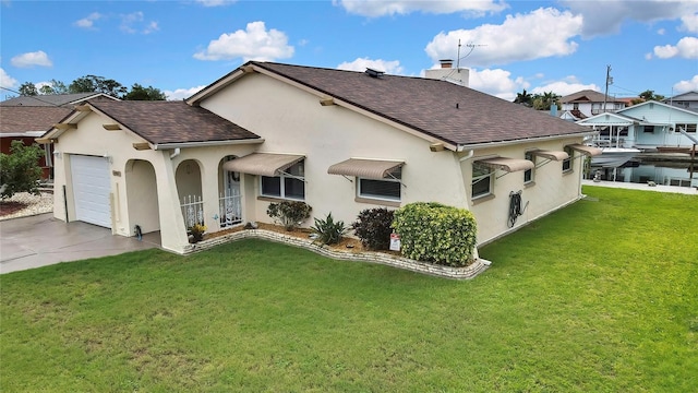 13814 Lavender Ave, Hudson, FL 34667 - back of property featuring a shingled roof, stucco siding, and an attached garage