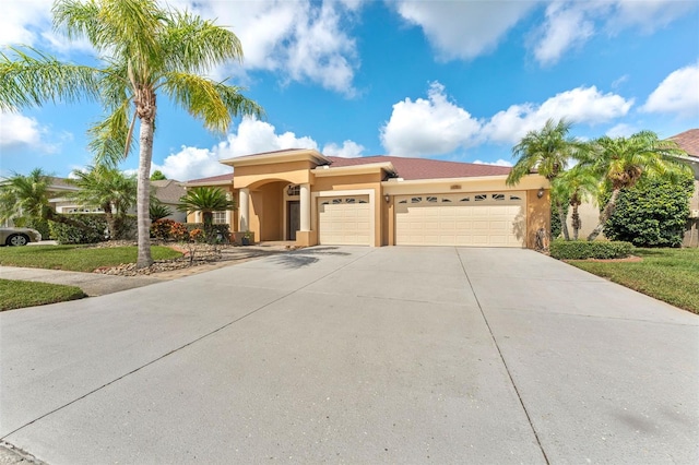 5309 Spectacular Bid Dr, Wesley Chapel, FL 33544 - mediterranean / spanish home with an attached garage, stucco siding, and driveway