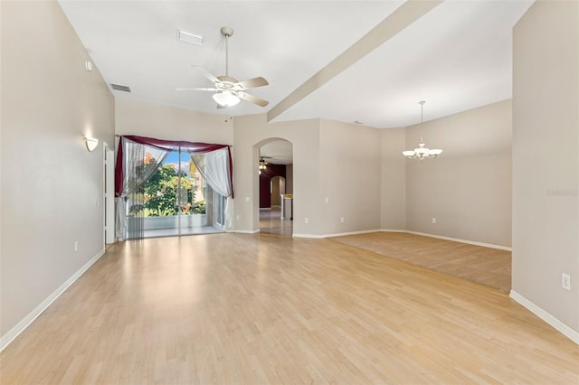 5309 Spectacular Bid Dr, Wesley Chapel, FL 33544 - unfurnished room with ceiling fan, arched walkways, a chandelier, and light wood-type flooring