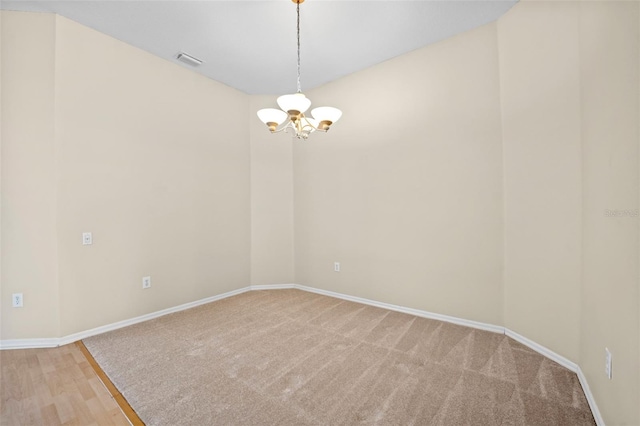 5309 Spectacular Bid Dr, Wesley Chapel, FL 33544 - spare room featuring a chandelier and light colored carpet