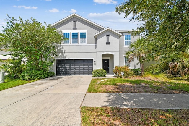 11541 Tangle Branch Ln, Gibsonton, FL 33534 - view of front of home with an attached garage, stucco siding, and concrete driveway