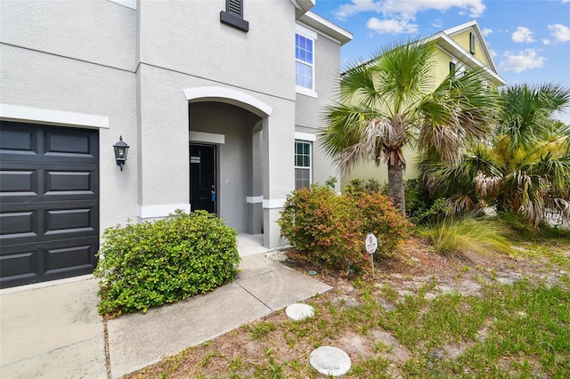 11541 Tangle Branch Ln, Gibsonton, FL 33534 - view of exterior entry featuring stucco siding and a garage