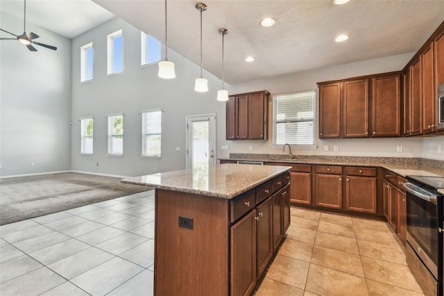 11541 Tangle Branch Ln, Gibsonton, FL 33534 - kitchen featuring stainless steel electric range oven, ceiling fan, light colored carpet, recessed lighting, and light stone counters