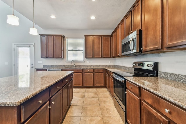 11541 Tangle Branch Ln, Gibsonton, FL 33534 - kitchen with appliances with stainless steel finishes, recessed lighting, decorative light fixtures, stone countertops, and light tile patterned flooring