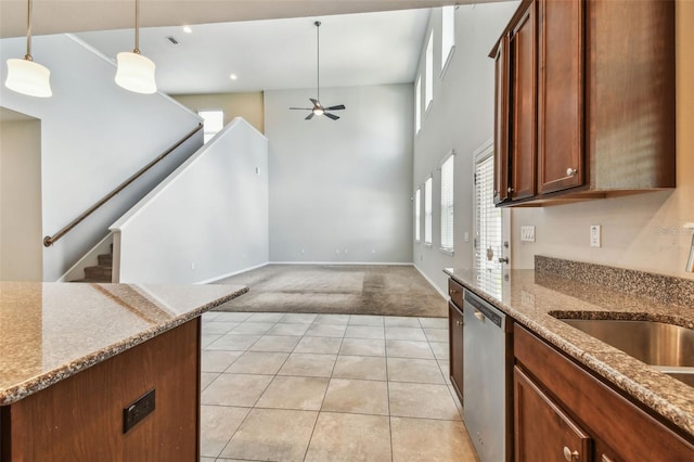 11541 Tangle Branch Ln, Gibsonton, FL 33534 - kitchen with dishwasher, light colored carpet, ceiling fan, light tile patterned floors, and hanging light fixtures