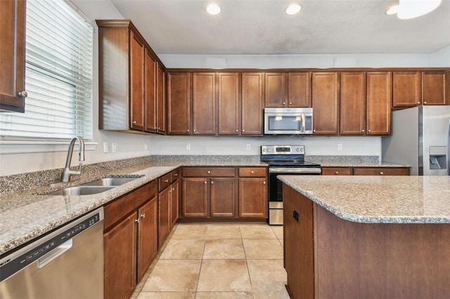 11541 Tangle Branch Ln, Gibsonton, FL 33534 - kitchen featuring appliances with stainless steel finishes, light stone counters, recessed lighting, and light tile patterned floors