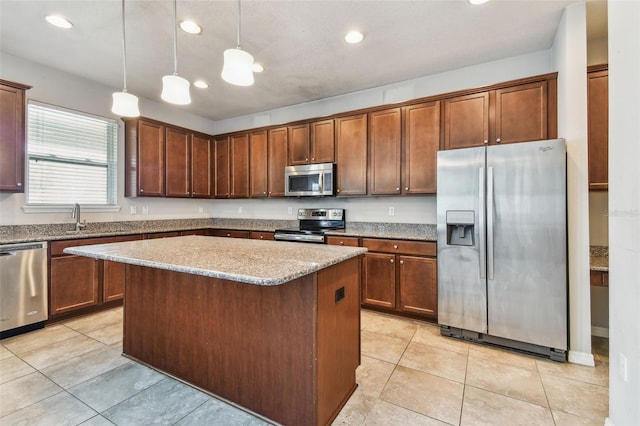 11541 Tangle Branch Ln, Gibsonton, FL 33534 - kitchen featuring stainless steel appliances, a kitchen island, recessed lighting, hanging light fixtures, and light stone counters