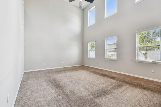 11541 Tangle Branch Ln, Gibsonton, FL 33534 - carpeted empty room featuring a ceiling fan and a high ceiling
