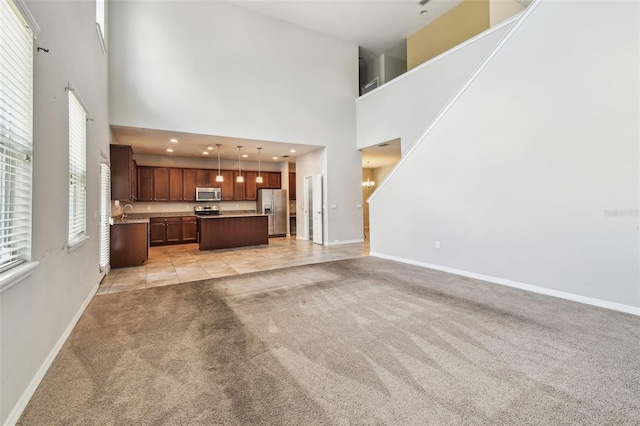 11541 Tangle Branch Ln, Gibsonton, FL 33534 - unfurnished living room with light colored carpet, a towering ceiling, and light tile patterned flooring