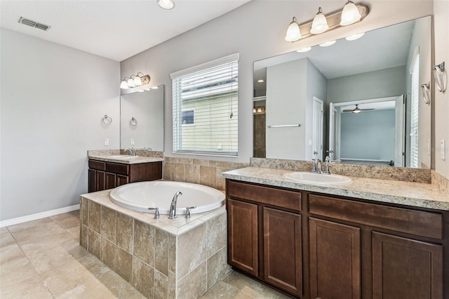 11541 Tangle Branch Ln, Gibsonton, FL 33534 - full bathroom with a bath, two vanities, a ceiling fan, and tile patterned floors