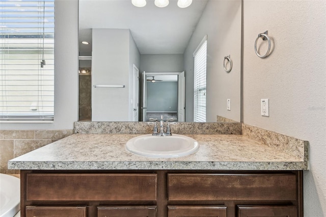 11541 Tangle Branch Ln, Gibsonton, FL 33534 - bathroom featuring vanity, a ceiling fan, and a tub to relax in