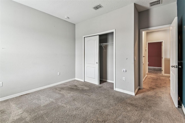 11541 Tangle Branch Ln, Gibsonton, FL 33534 - unfurnished bedroom with carpet, a closet, and a textured ceiling