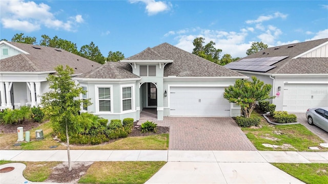 2132 Limestone Trl, Kissimmee, FL 34747 - view of front facade featuring a garage, driveway, roof with shingles, and stucco siding