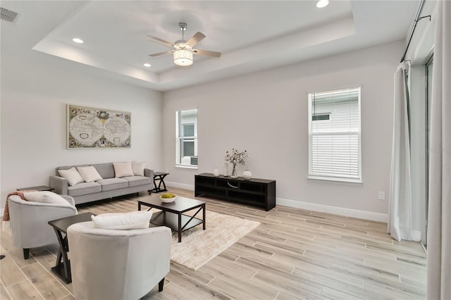 2132 Limestone Trl, Kissimmee, FL 34747 - living room with a tray ceiling, healthy amount of natural light, light wood-type flooring, and recessed lighting