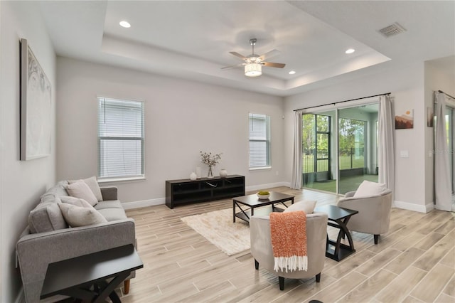 2132 Limestone Trl, Kissimmee, FL 34747 - living area with a tray ceiling, light wood-style floors, recessed lighting, and ceiling fan