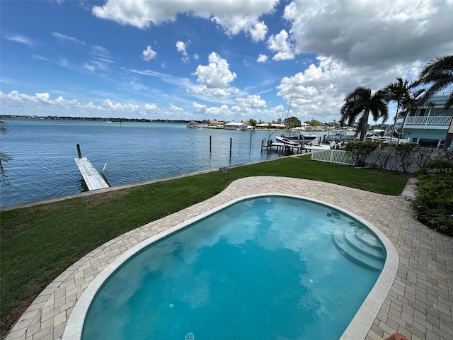 413 Midway Is, Clearwater Beach, FL 33767 - view of swimming pool featuring a water view, a lawn, and a boat dock