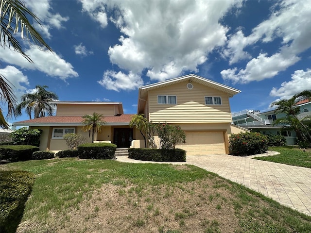 413 Midway Is, Clearwater Beach, FL 33767 - view of front facade featuring a front lawn, a garage, driveway, and stucco siding