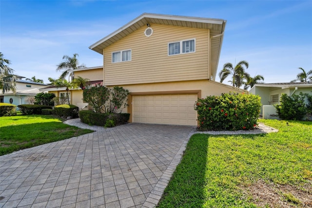 413 Midway Is, Clearwater Beach, FL 33767 - view of front facade with a garage, decorative driveway, stucco siding, and a front yard