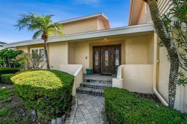413 Midway Is, Clearwater Beach, FL 33767 - property entrance featuring stucco siding
