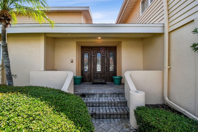 413 Midway Is, Clearwater Beach, FL 33767 - view of exterior entry featuring stucco siding