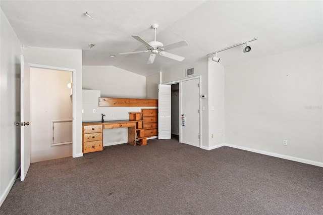 413 Midway Is, Clearwater Beach, FL 33767 - unfurnished bedroom with dark carpet, lofted ceiling, track lighting, ceiling fan, and a desk