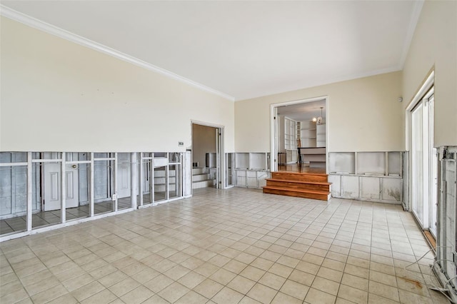 413 Midway Is, Clearwater Beach, FL 33767 - tiled spare room with ornamental molding, stairs, and plenty of natural light