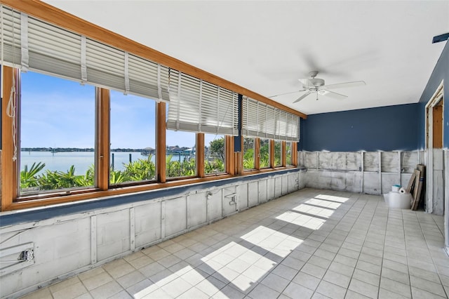 413 Midway Is, Clearwater Beach, FL 33767 - unfurnished sunroom featuring a water view and tile patterned floors
