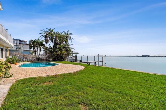 413 Midway Is, Clearwater Beach, FL 33767 - outdoor pool with a lawn, a patio, a water view, boat lift, and a boat dock