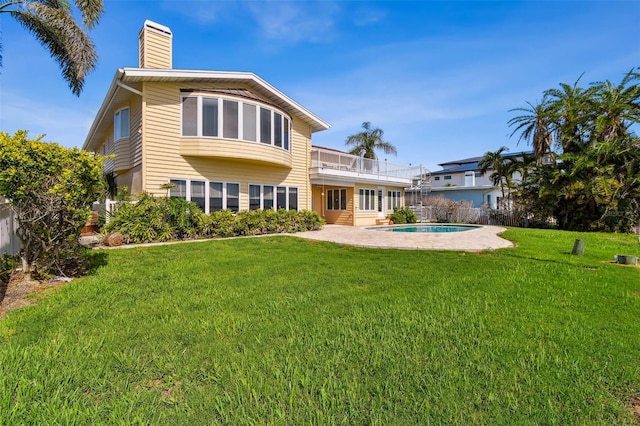 413 Midway Is, Clearwater Beach, FL 33767 - back of house featuring a balcony, a chimney, and a patio