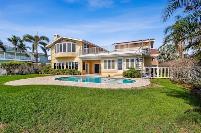 413 Midway Is, Clearwater Beach, FL 33767 - back of house with a balcony, a chimney, and a patio area