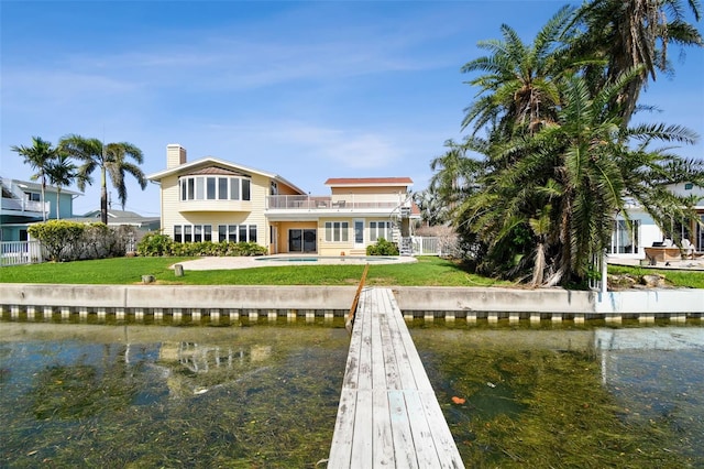 413 Midway Is, Clearwater Beach, FL 33767 - rear view of house featuring a balcony, a water view, a chimney, and a pool