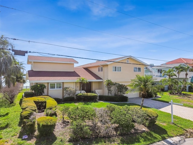 413 Midway Is, Clearwater Beach, FL 33767 - view of front of house with decorative driveway and an attached garage