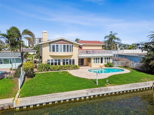 413 Midway Is, Clearwater Beach, FL 33767 - rear view of property featuring a balcony, a patio, an outdoor pool, and a water view