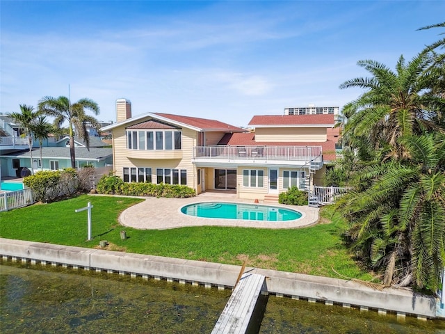 413 Midway Is, Clearwater Beach, FL 33767 - back of house featuring a balcony, a patio, an outdoor pool, stairs, and a chimney