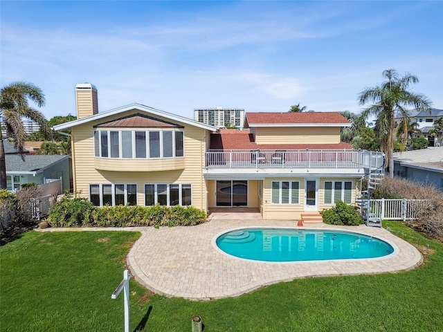 413 Midway Is, Clearwater Beach, FL 33767 - rear view of house featuring a balcony, a patio, a chimney, an outdoor pool, and entry steps