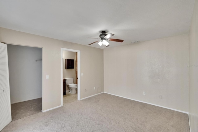 1331 Coolmont Dr, Brandon, FL 33511 - unfurnished bedroom featuring carpet flooring, a walk in closet, a closet, ensuite bathroom, and ceiling fan