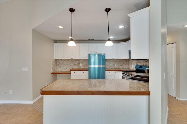 1331 Coolmont Dr, Brandon, FL 33511 - kitchen with appliances with stainless steel finishes, decorative backsplash, light tile patterned floors, white cabinets, and recessed lighting