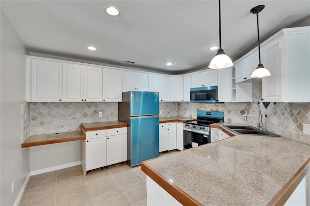 1331 Coolmont Dr, Brandon, FL 33511 - kitchen with appliances with stainless steel finishes, white cabinetry, a peninsula, tasteful backsplash, and recessed lighting