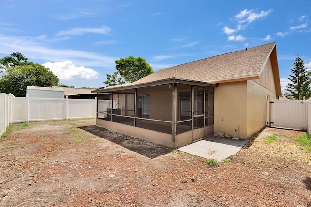 1331 Coolmont Dr, Brandon, FL 33511 - back of property with a sunroom, roof with shingles, a fenced backyard, and stucco siding