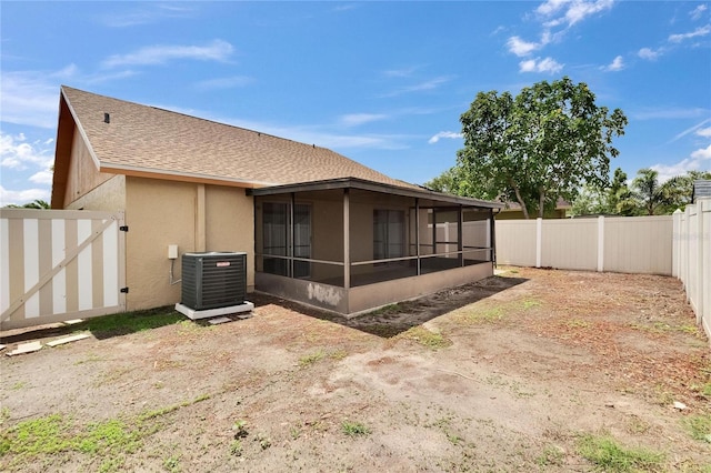 1331 Coolmont Dr, Brandon, FL 33511 - rear view of property featuring a sunroom, a fenced backyard, roof with shingles, and stucco siding
