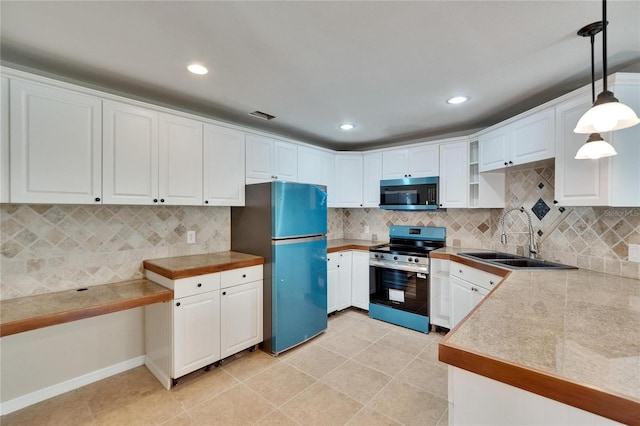 1331 Coolmont Dr, Brandon, FL 33511 - kitchen with stainless steel appliances, white cabinets, tasteful backsplash, pendant lighting, and recessed lighting