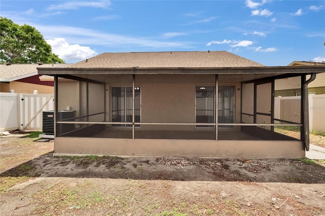 1331 Coolmont Dr, Brandon, FL 33511 - rear view of house featuring a sunroom, roof with shingles, and stucco siding
