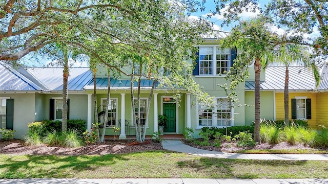 5518 Luminar Pointe Ln, Apollo Beach, FL 33572 - view of front of property with covered porch, a standing seam roof, stucco siding, and a metal roof