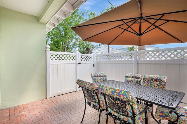 5518 Luminar Pointe Ln, Apollo Beach, FL 33572 - view of patio / terrace with a gate and outdoor dining space