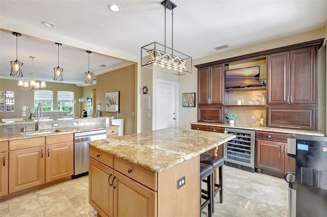 5518 Luminar Pointe Ln, Apollo Beach, FL 33572 - kitchen with stainless steel dishwasher, beverage cooler, a chandelier, a center island, and light stone counters