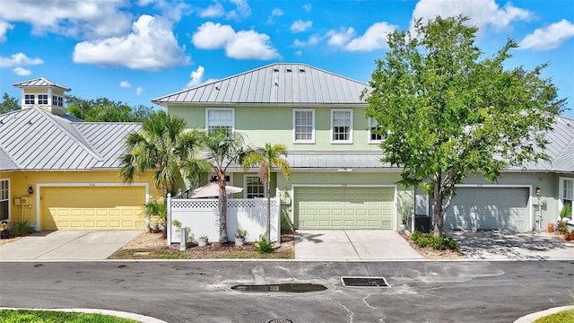 5518 Luminar Pointe Ln, Apollo Beach, FL 33572 - view of front of home featuring a standing seam roof, a metal roof, stucco siding, and concrete driveway