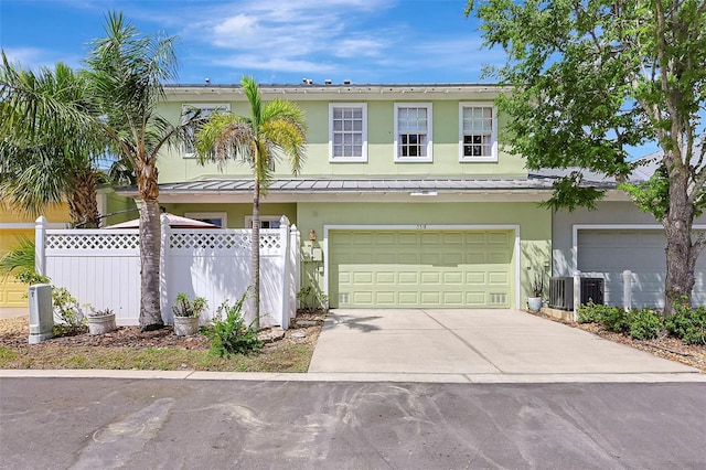 5518 Luminar Pointe Ln, Apollo Beach, FL 33572 - traditional home featuring stucco siding, a standing seam roof, a garage, driveway, and a metal roof